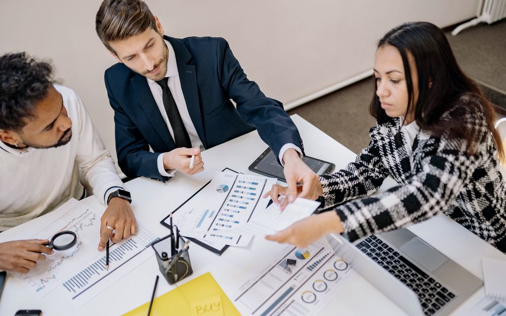 Advisors reviewing charts together at a meeting table