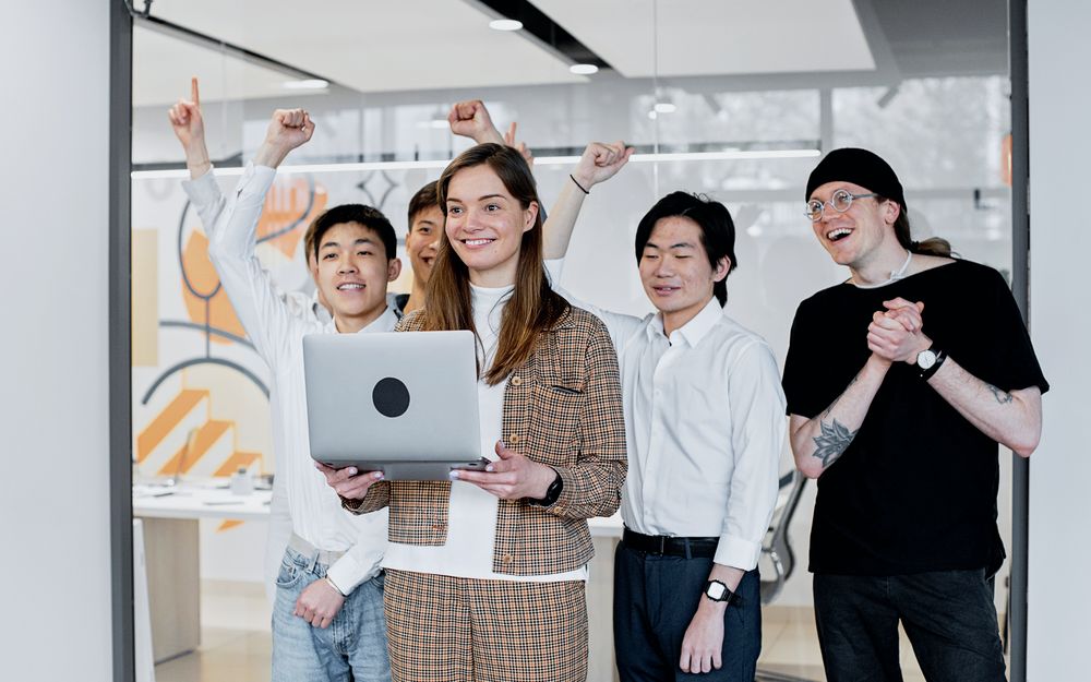 A team celebrating a shared win in the office